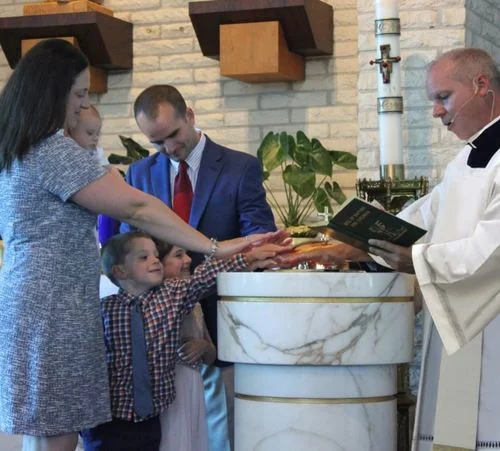 Caitlin Fanelli and family at a baptism.